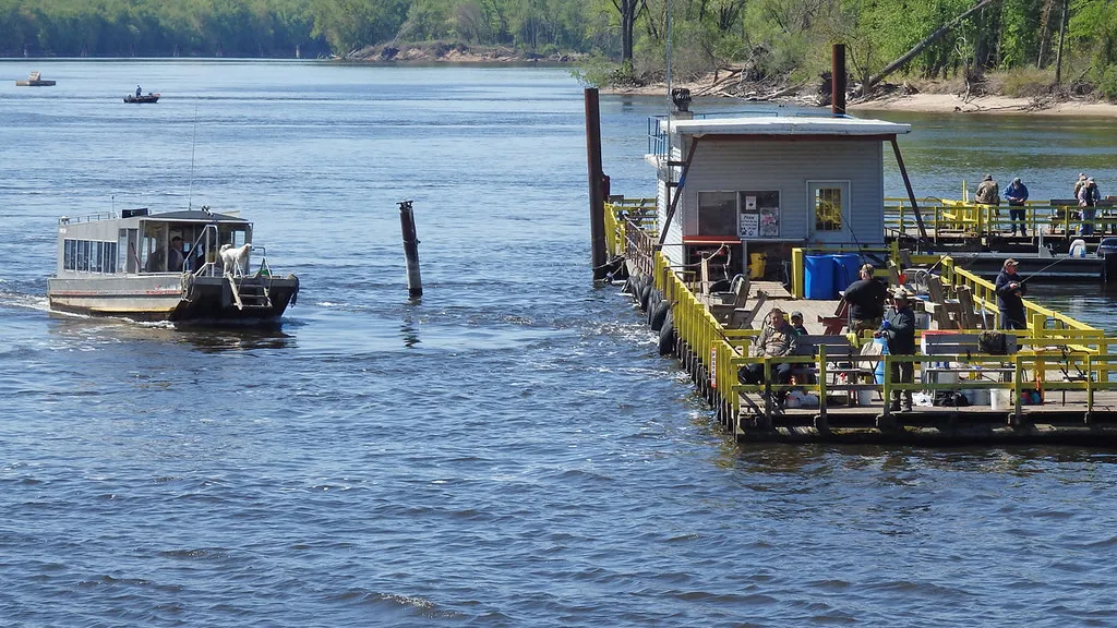 Anglers fishing from Clements Fishing Barge on the Mississippi River at Genoa, with the shuttle boat coming in