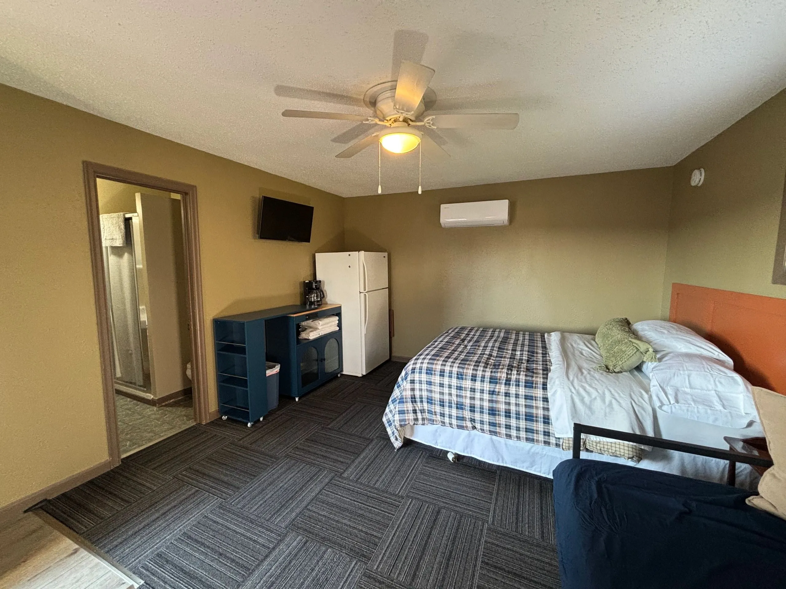 Motel room showing the queen bed, single bed, refrigerator, coffee maker and TV